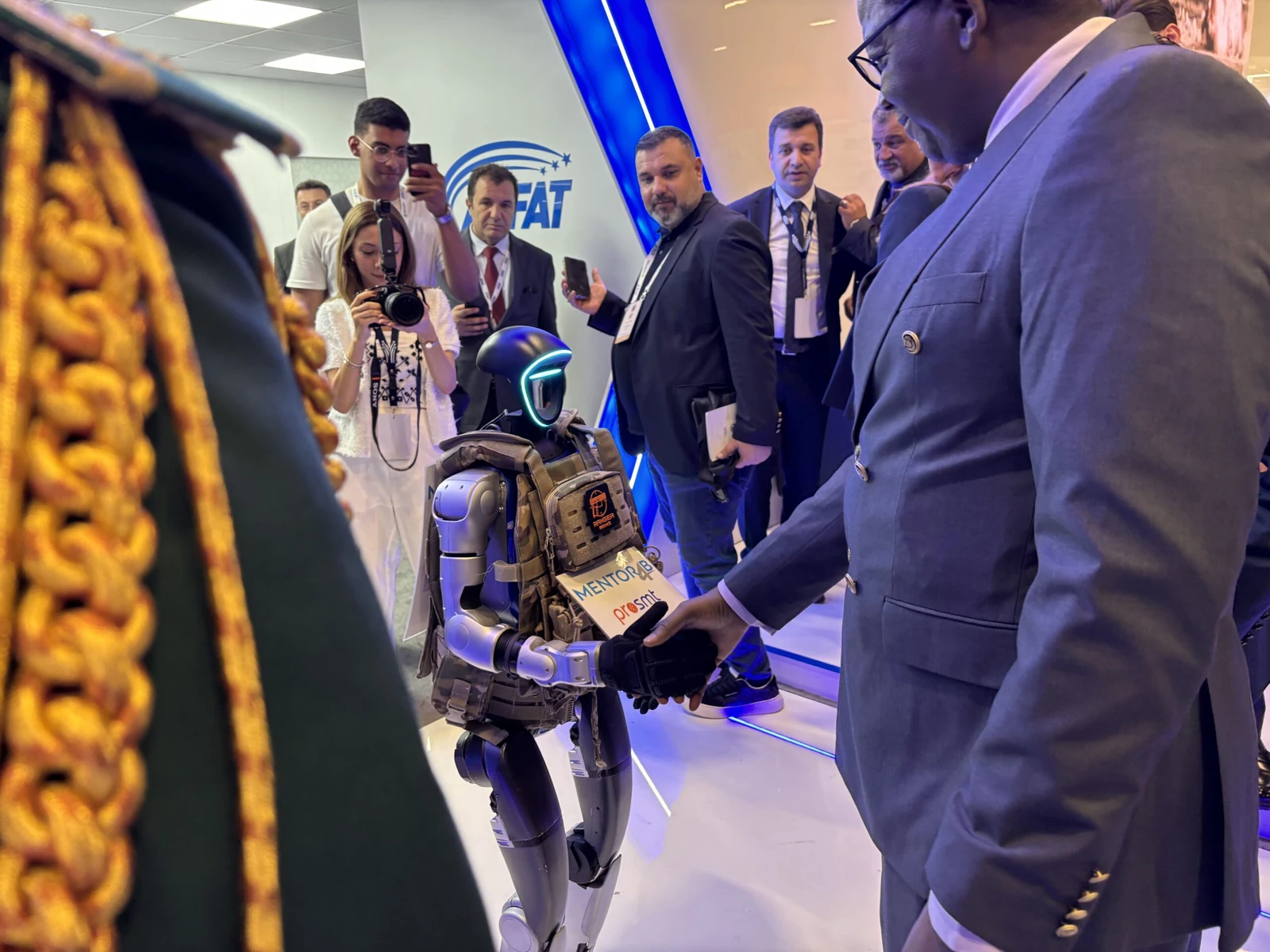 Unitree G1 humanoid robot alongside event professionals at a corporate demonstration