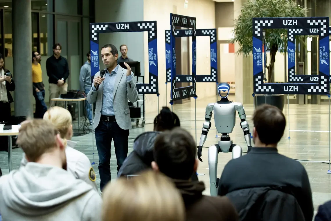 Unitree G1 robot on stage at university event, demonstrating hire humanoid robot for presentations