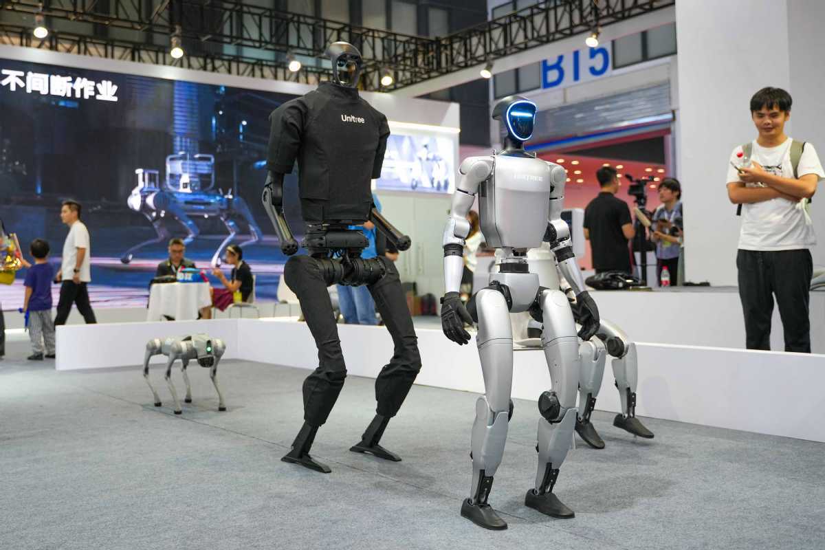 Unitree G1 humanoid robot for trade show on exhibition floor with attendees watching live demo