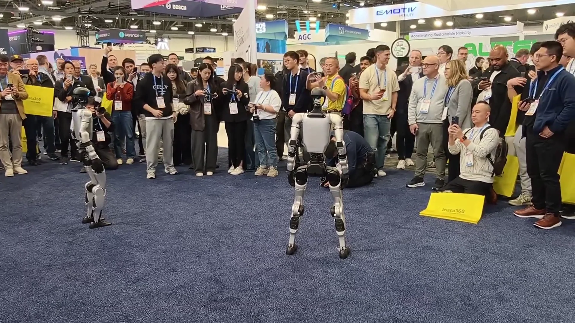 Two Unitree G1 humanoid robots at CES 2026 trade show floor — ZMProbots fleet available for event rental