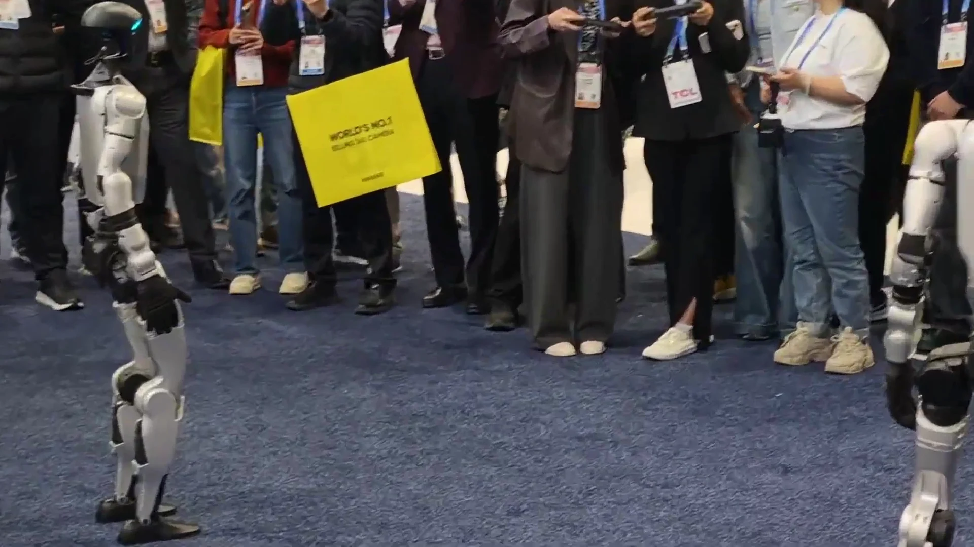 Unitree G1 humanoid robot at CES 2026 trade show interacting with attendees on the exhibition floor