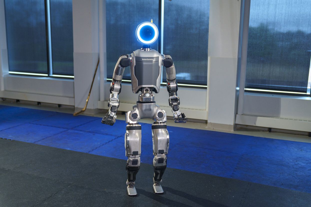 Boston Dynamics electric Atlas humanoid robot standing upright demonstrating full-body range of motion with 56 joints