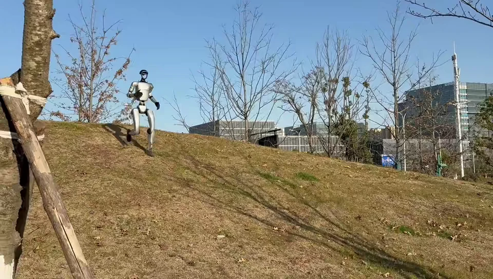 Unitree G1 humanoid robot jogging through a public park on an outdoor mobility demonstration