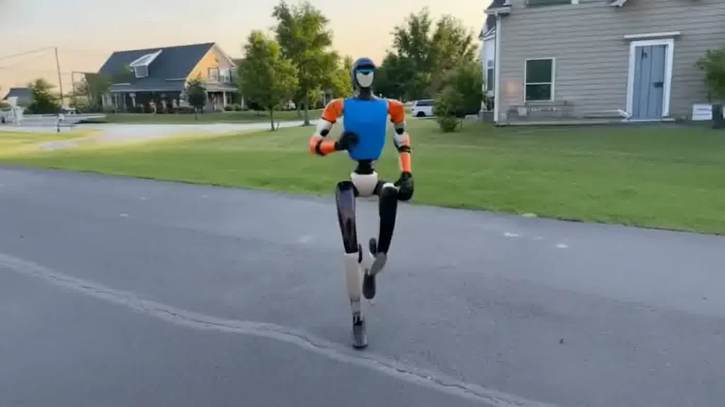 Unitree G1 humanoid robot at a corporate event venue standing in front of an audience during a live presentation moment