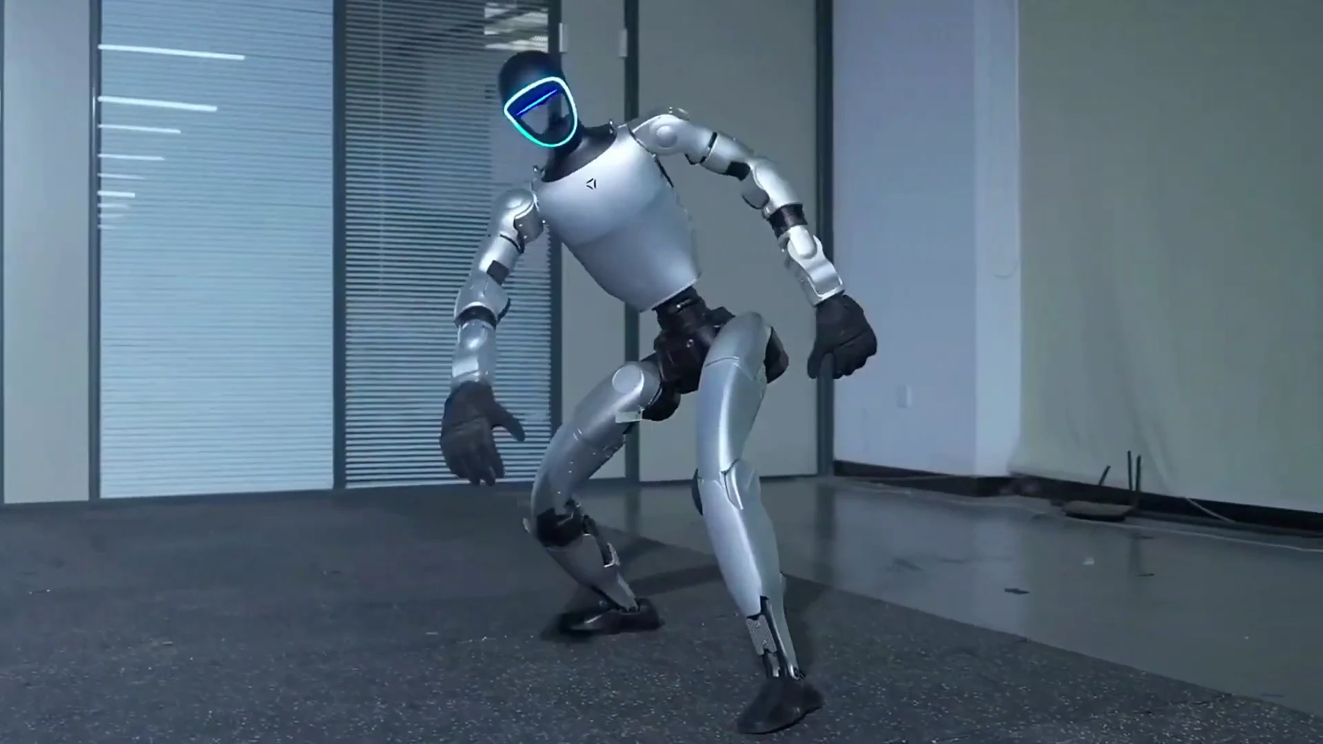 Unitree G1 humanoid robot in an indoor warehouse setting during preparation before an event deployment