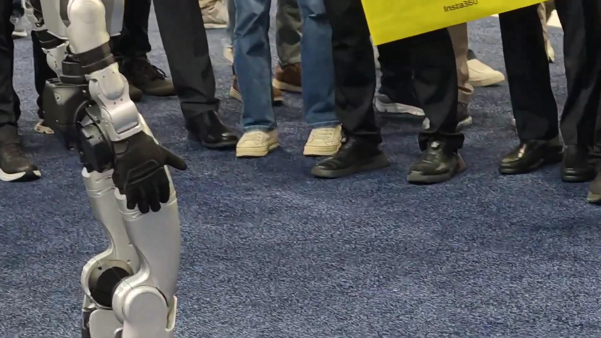Unitree G1 humanoid robot demonstrating to a crowd at CES 2026, showing battery-efficient demo loop operation