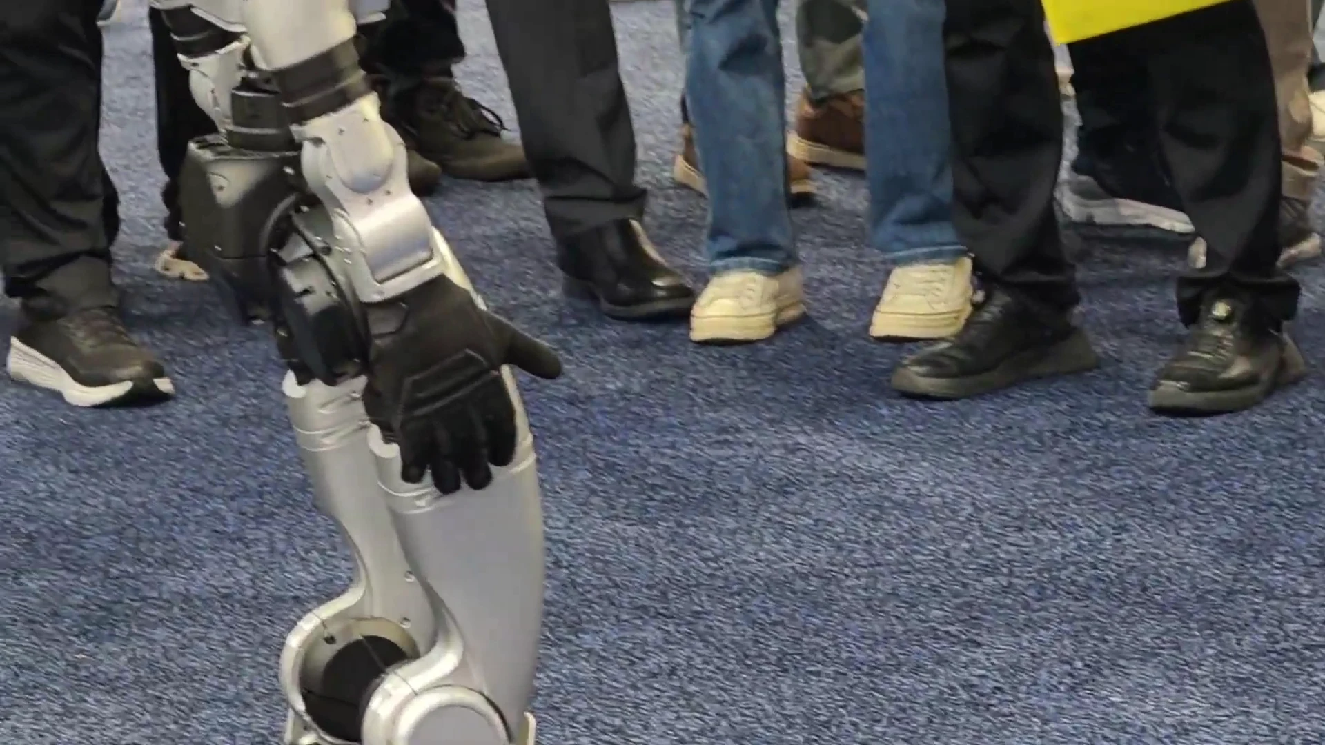 Unitree G1 robot surrounded by event attendees, illustrating crowd safety and supervised operation protocols