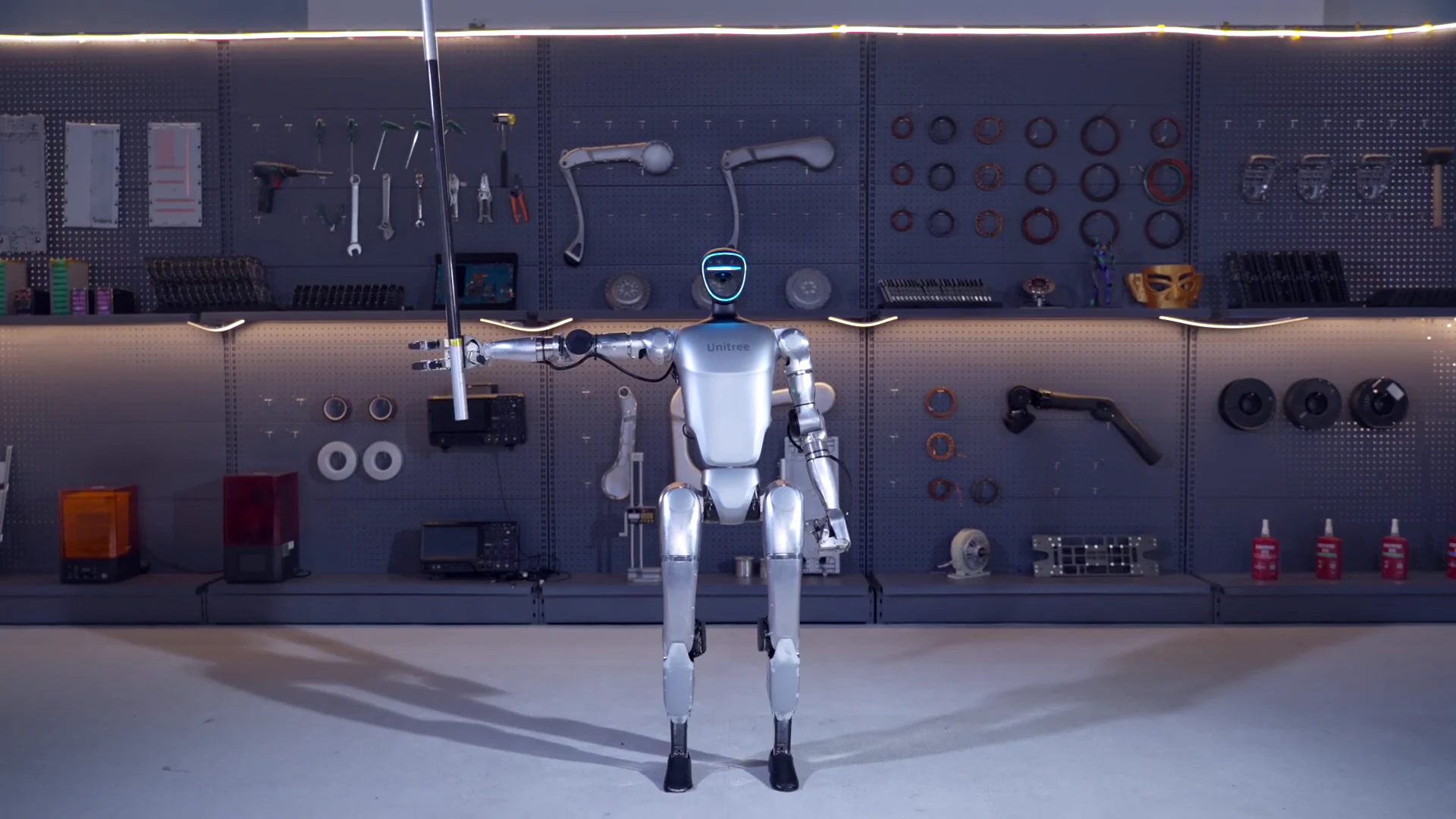 Unitree G1 humanoid robot moving through an indoor warehouse during a training session