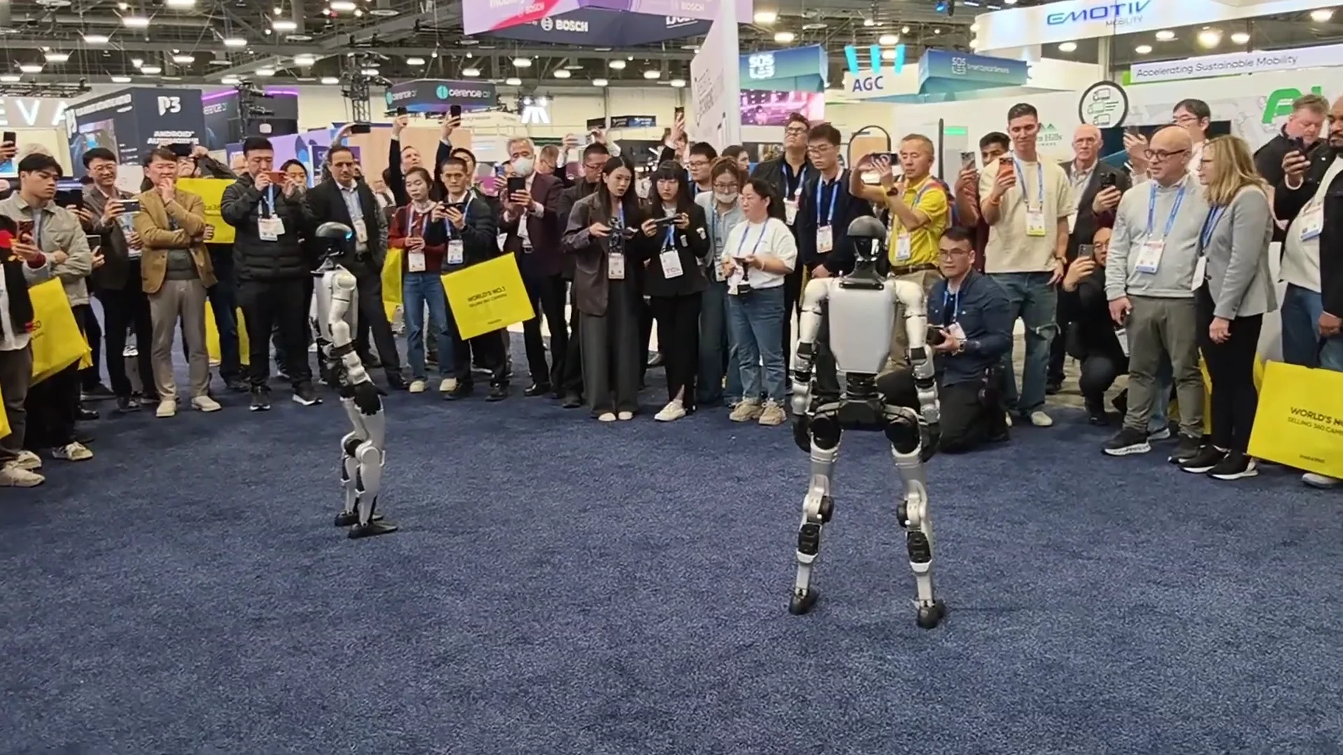 Unitree G1 humanoid robot at CES Las Vegas trade show with a crowd gathered around the demo area