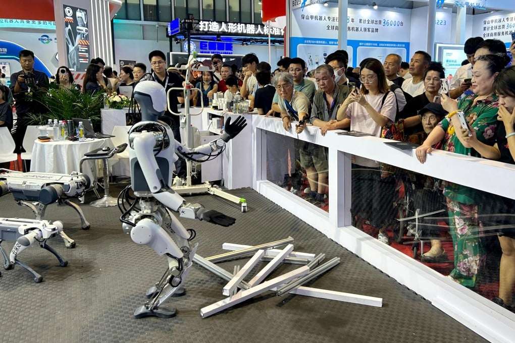 Humanoid robot at a trade show exhibition floor engaging booth visitors during a live demonstration event