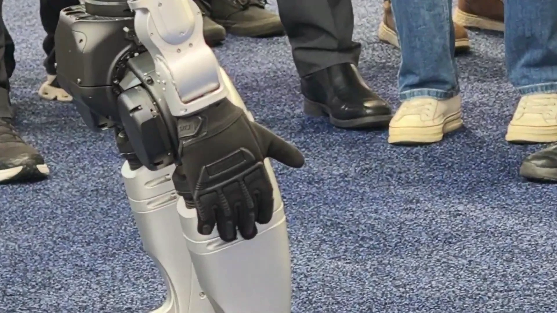 Unitree G1 humanoid robot engaging a crowd of attendees at a major trade show brand activation event