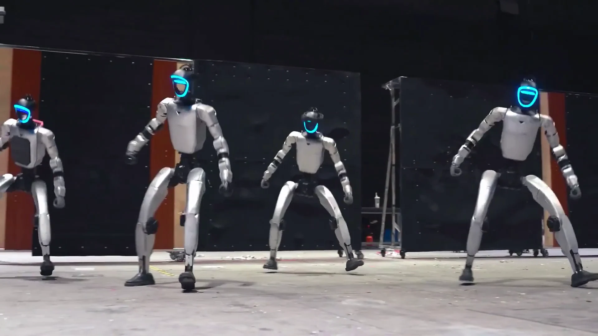 Unitree G1 humanoid robot performing demonstration movements in an indoor science center exhibit space