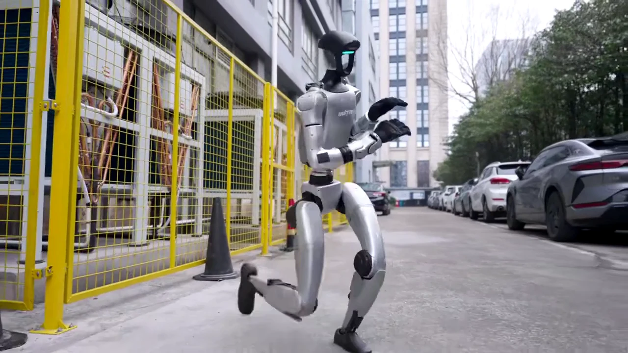 Unitree G1 humanoid robot walking through a city street during an outdoor public activation in an urban setting