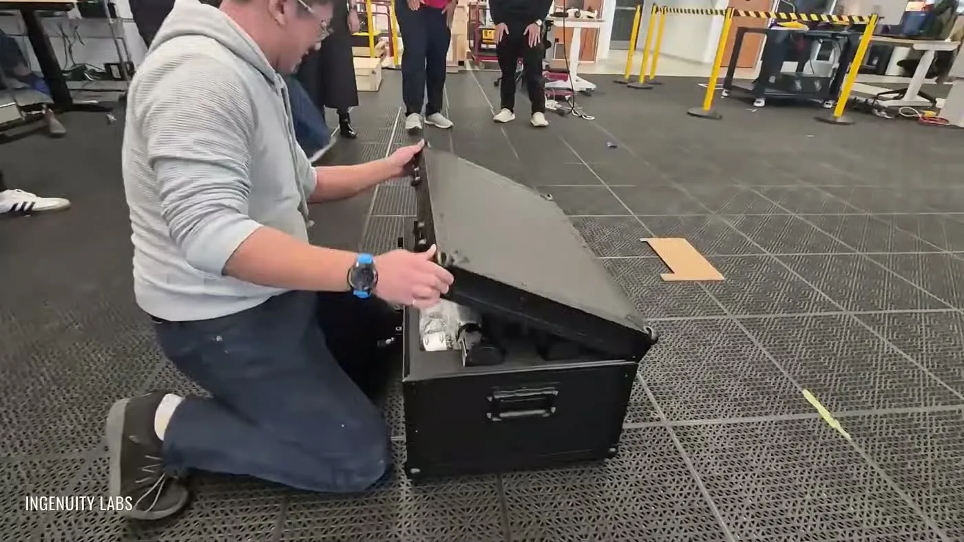 Operator unboxing a shipping case for robot hardware delivery, showing the logistics of cross-border rental