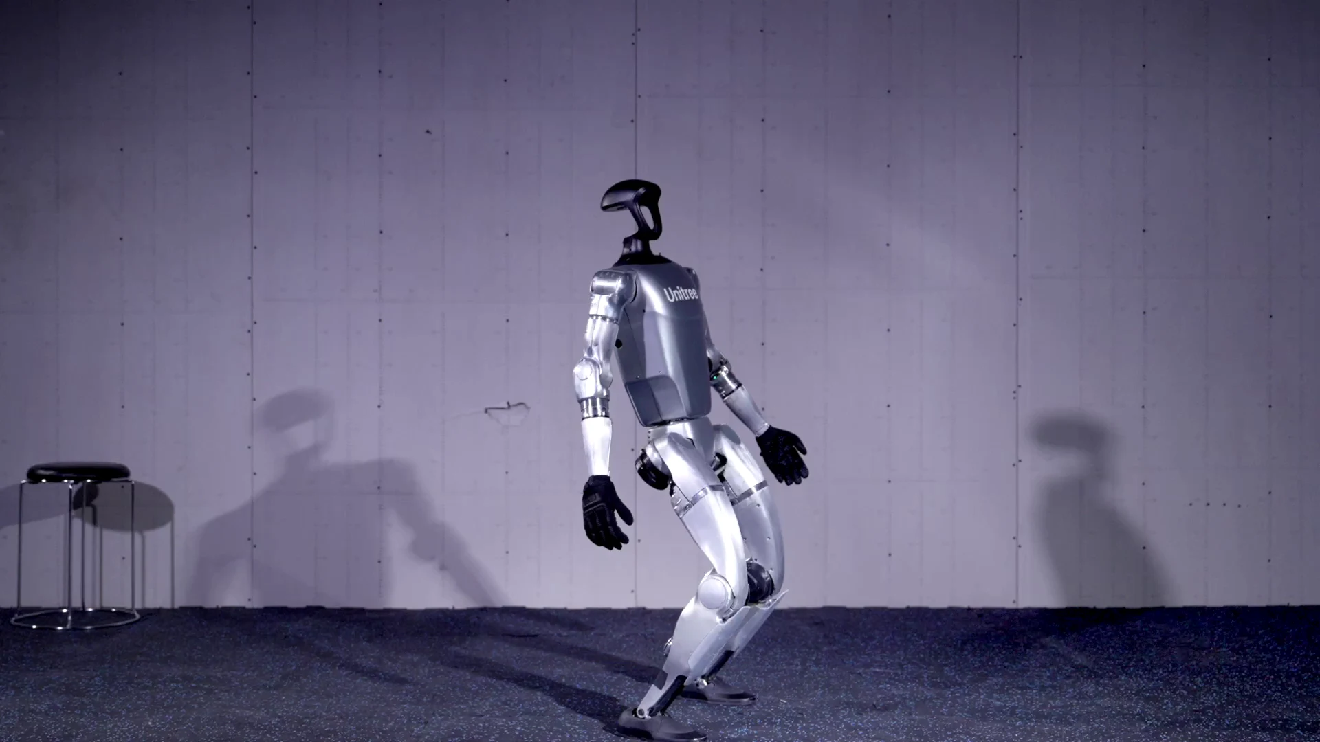 Unitree G1 humanoid robot in mid-stride in a studio, showing dynamic movement for European rental event deployments