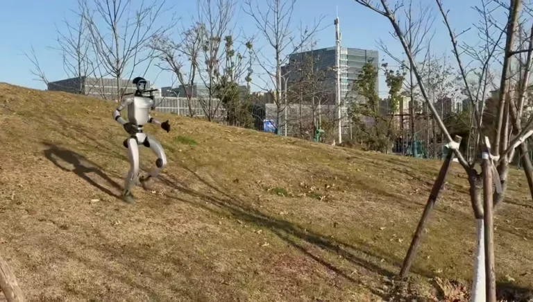 Unitree G1 humanoid robot walking on a city street demonstrating outdoor mobility and autonomous movement capability