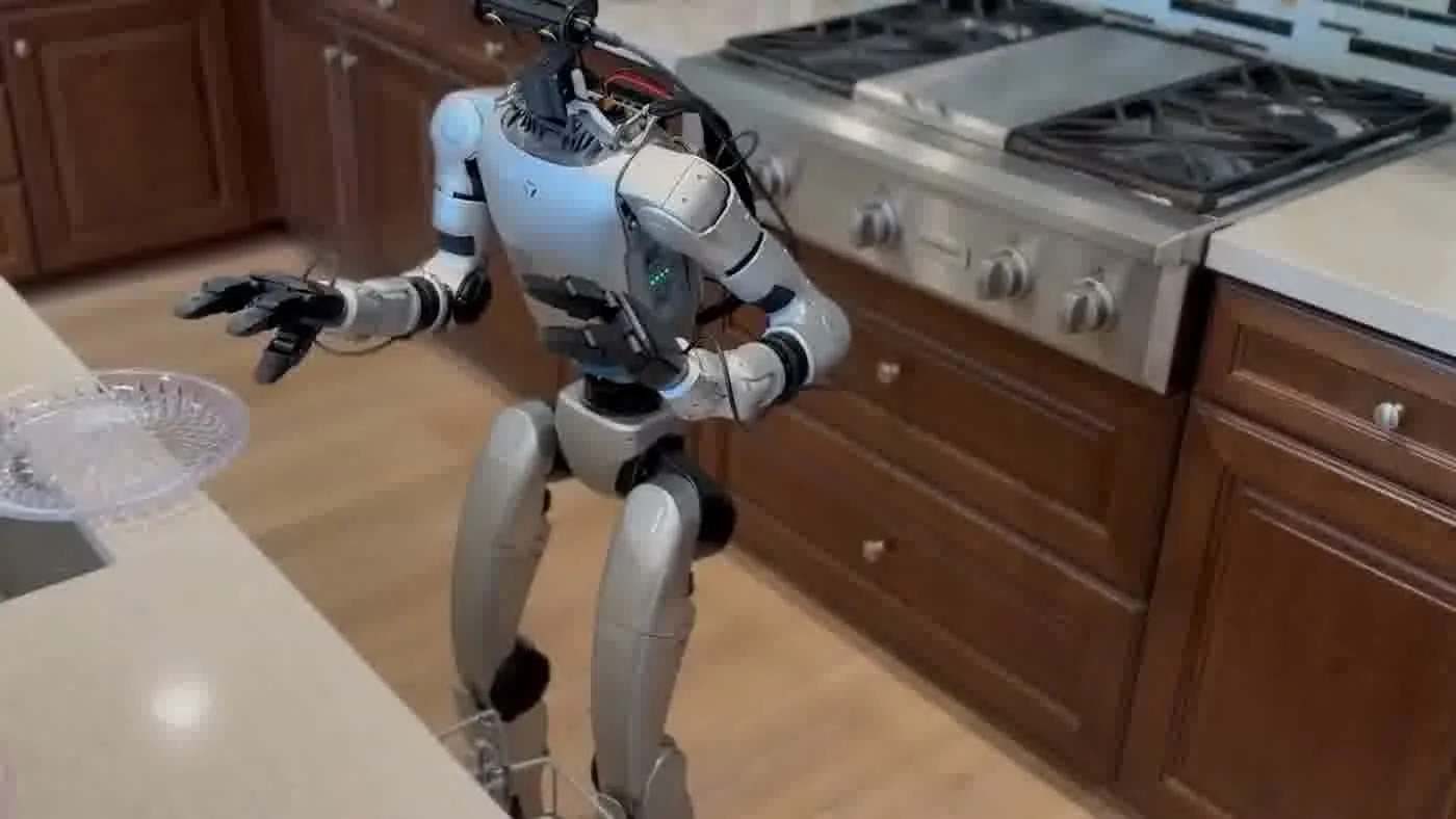 Unitree G1 robot with operator nearby during indoor event deployment illustrating active operator supervision protocol