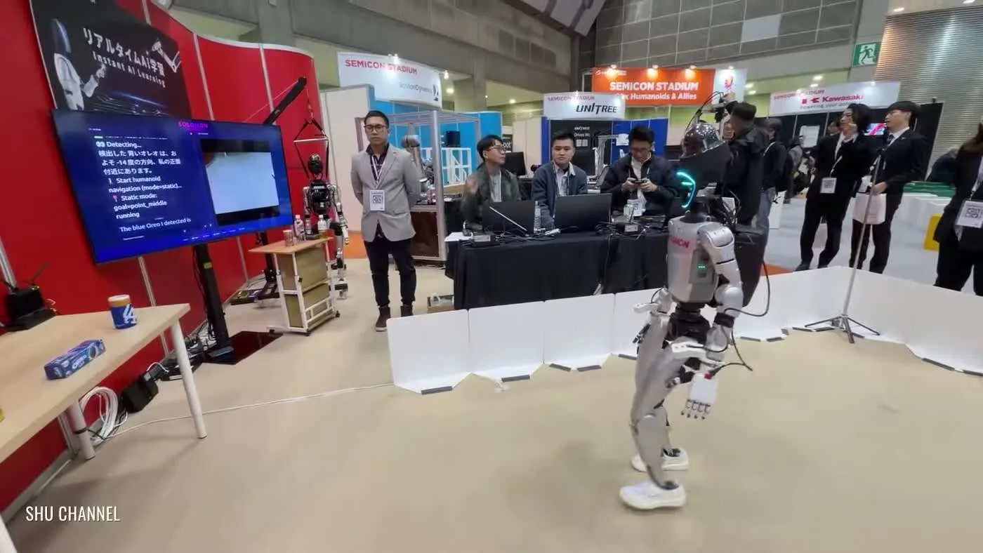 Unitree G1 humanoid robot walking at the Unitree Semicon Stadium booth during a major tech industry expo