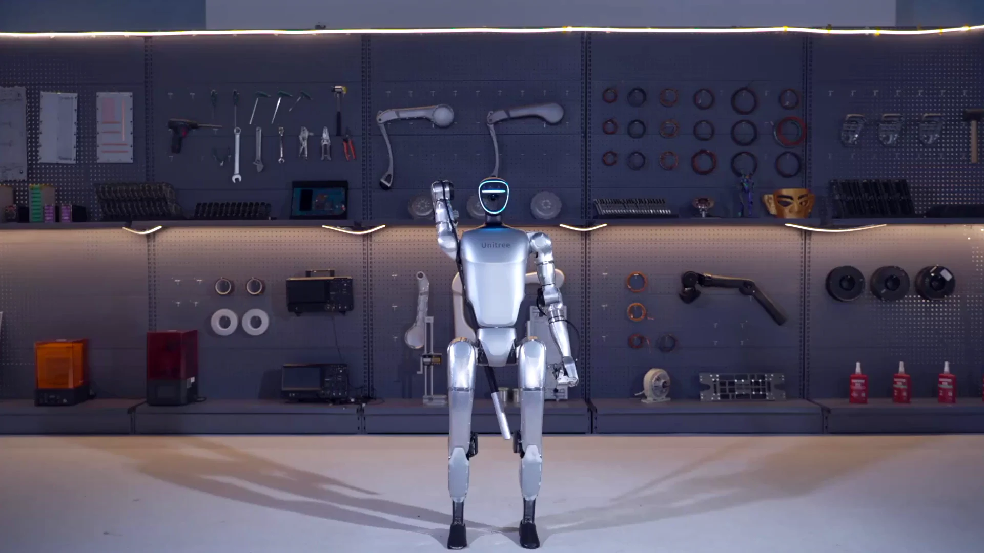 Unitree G1 humanoid robot in workshop introduction session showing actuator joints and mechanical frame structure